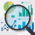 Magnifying glass over four different charts