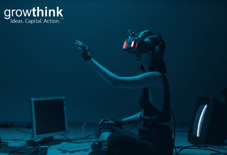 Woman wearing VR glasses with computer in front of her